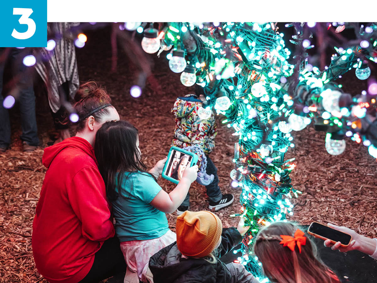 Adult and children sitting under magic tree